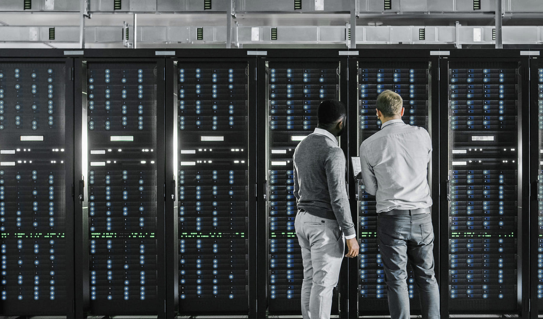 Data centre workers looking at equipment