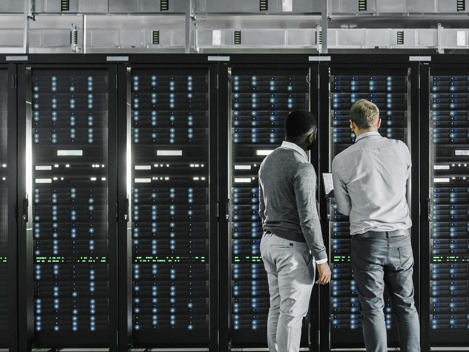 Data centre workers looking at equipment