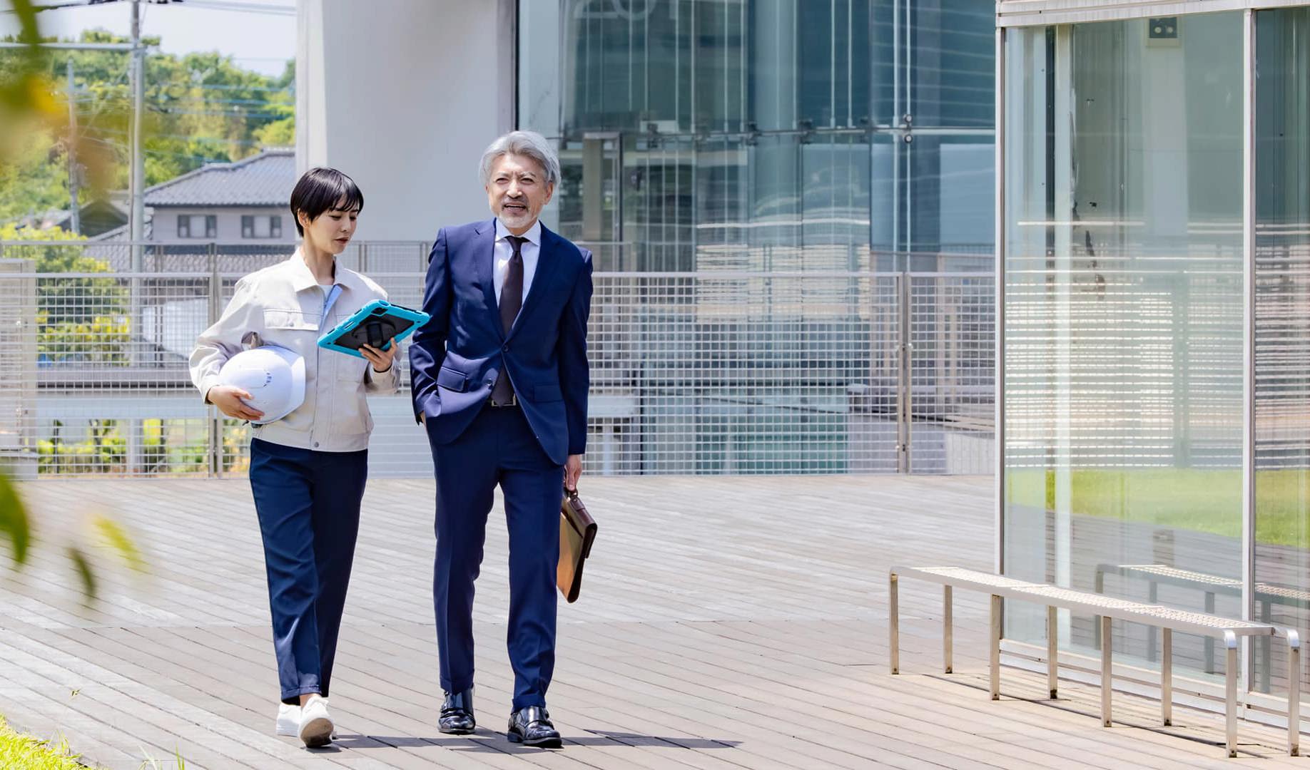 Two colleagues discussing information from a tablet