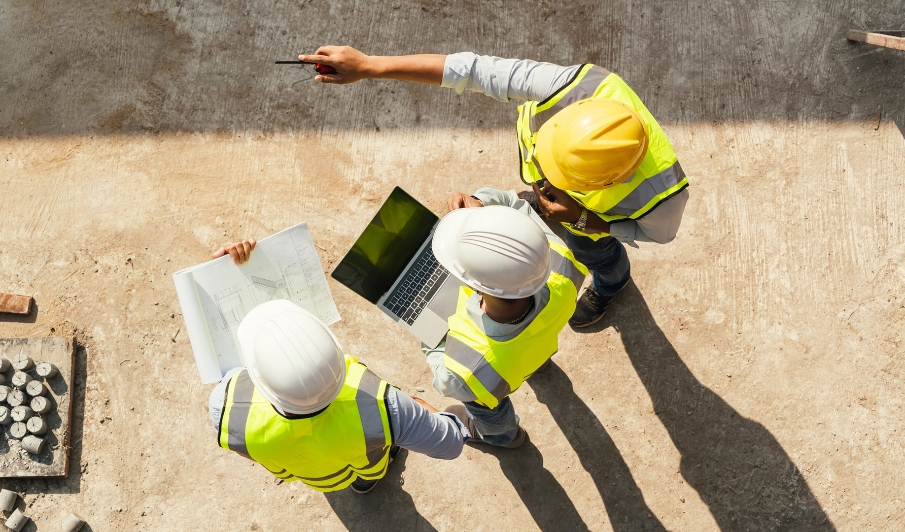 Three workers on a construction site