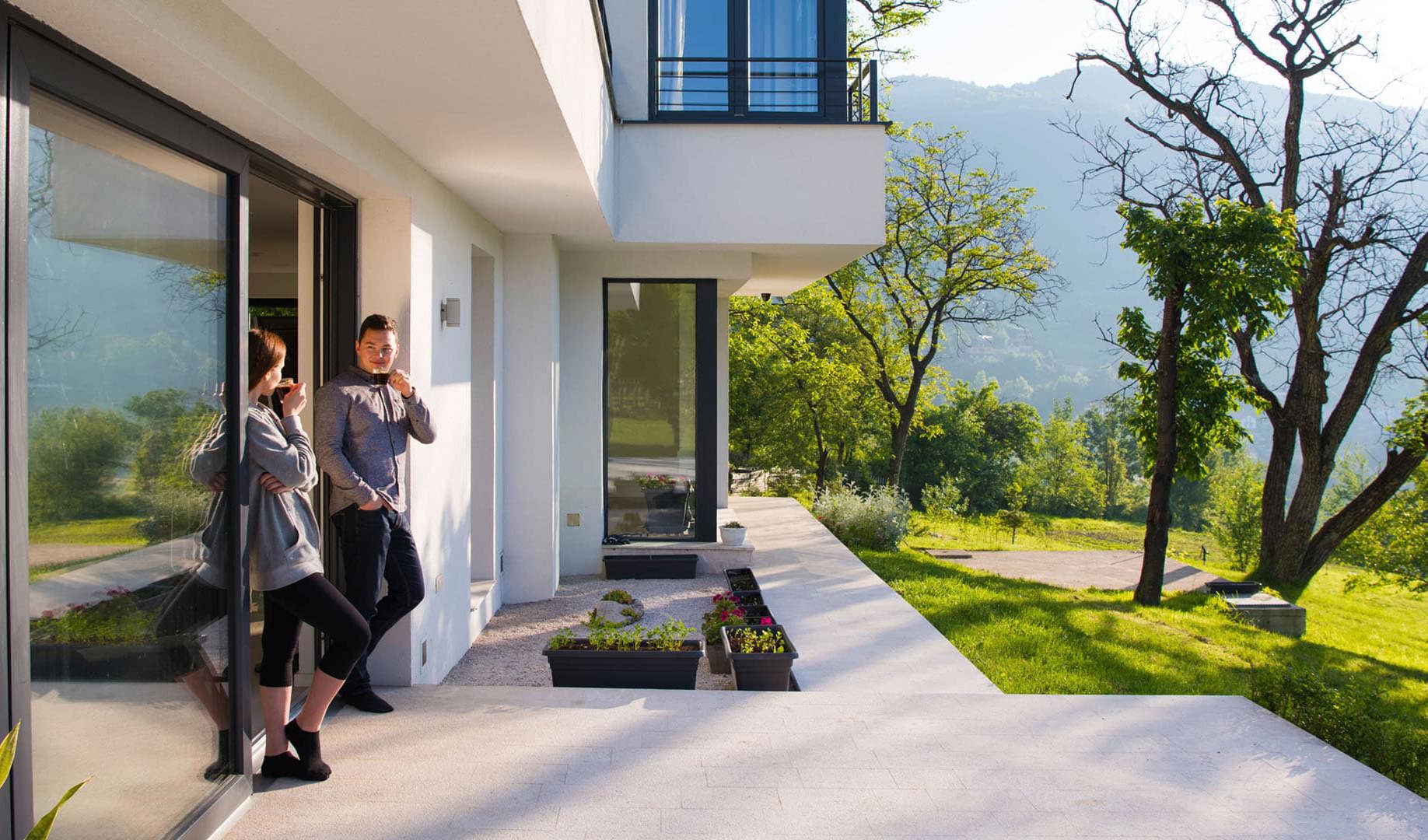 Two people standing at the doorway of a house