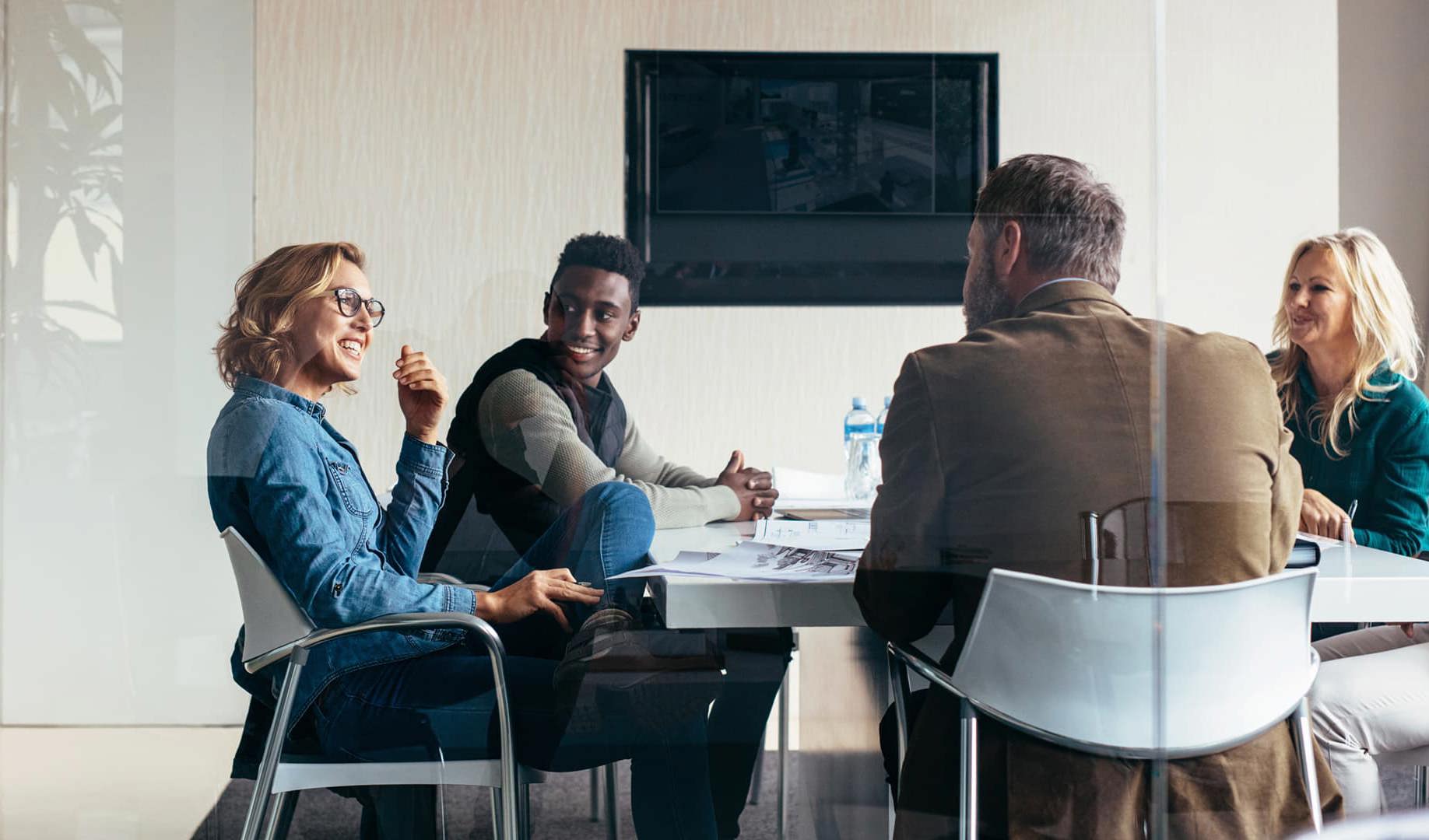 Five workers talking in a meeting