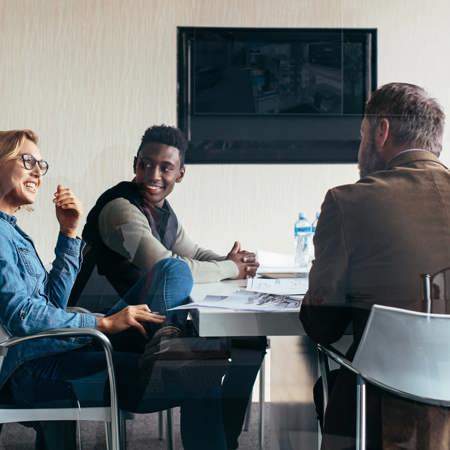 Five workers talking in a meeting